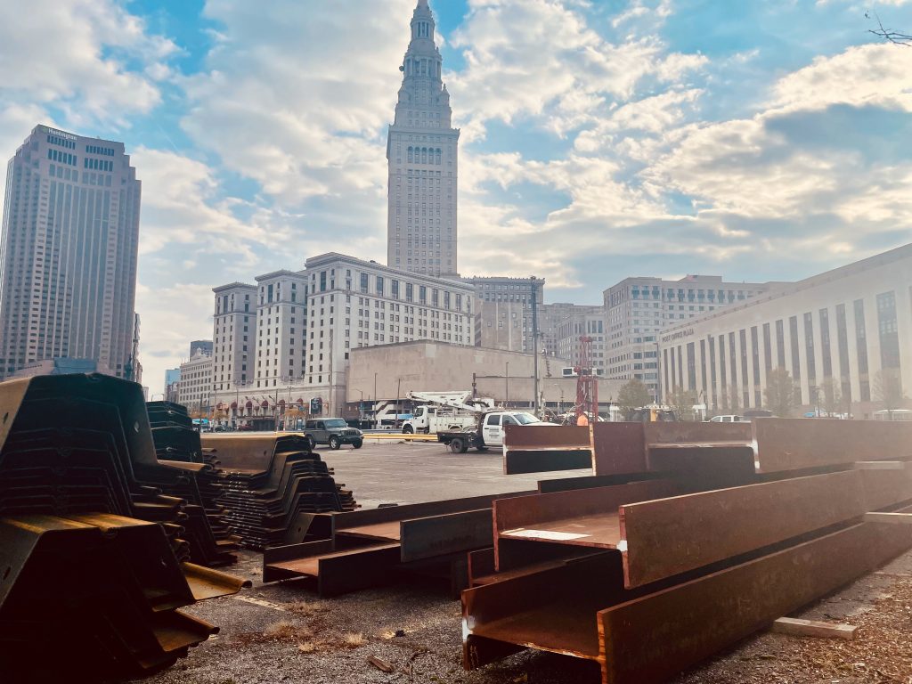 Steel beams sit in the foreground of Cleveland's terminal tower.